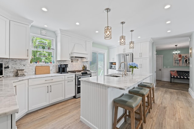 7 Passby Point Rd, Windham, ME 04062 - kitchen featuring appliances with stainless steel finishes, a chandelier, a sink, premium range hood, and decorative backsplash