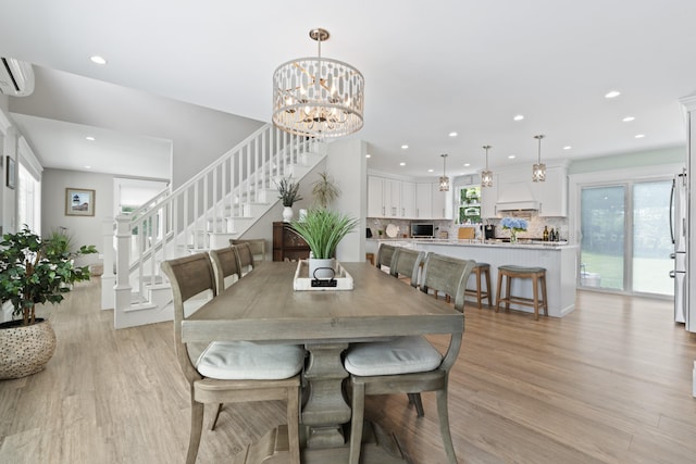 7 Passby Point Rd, Windham, ME 04062 - dining space featuring stairs, light wood-type flooring, recessed lighting, and a chandelier
