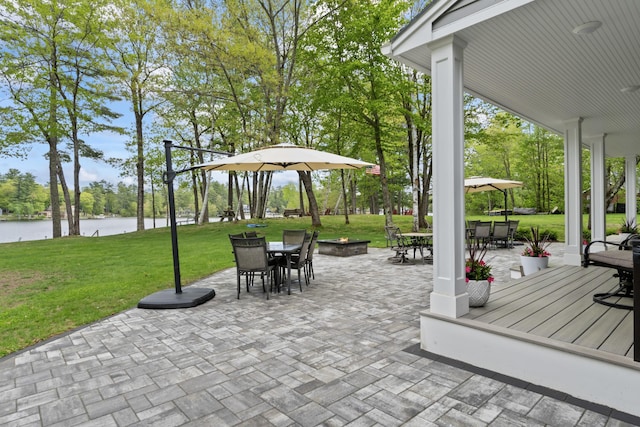 7 Passby Point Rd, Windham, ME 04062 - view of patio with outdoor dining space, a water view, view of scattered trees, and a fire pit