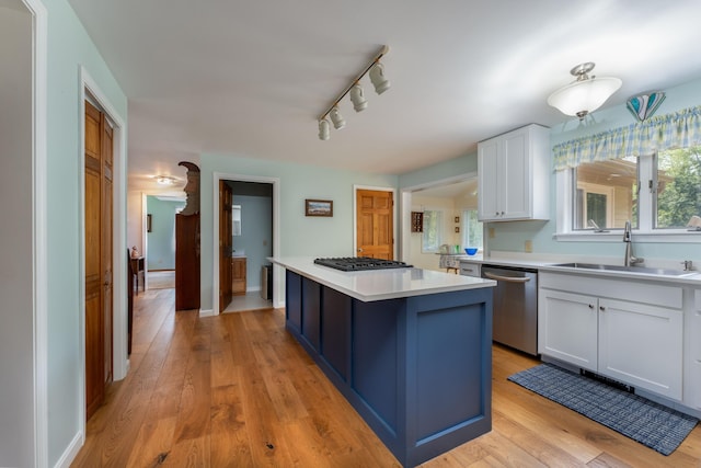 738 Litchfield Rd, Bowdoin, ME 04287 - kitchen featuring stainless steel dishwasher, a sink, white cabinetry, light countertops, and a center island