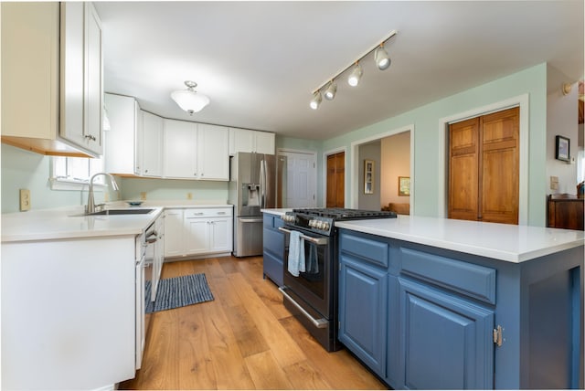 738 Litchfield Rd, Bowdoin, ME 04287 - kitchen with blue cabinets, a sink, stainless steel appliances, white cabinets, and light countertops
