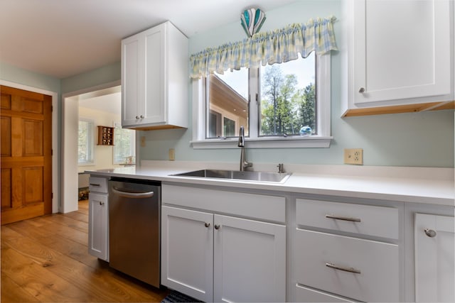 738 Litchfield Rd, Bowdoin, ME 04287 - kitchen featuring stainless steel dishwasher, a sink, white cabinetry, and wood finished floors