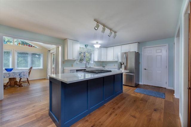 738 Litchfield Rd, Bowdoin, ME 04287 - kitchen featuring stainless steel refrigerator with ice dispenser, a sink, light countertops, gas stovetop, and white cabinetry