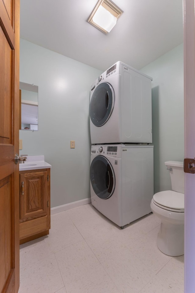 738 Litchfield Rd, Bowdoin, ME 04287 - laundry area with stacked washer / drying machine and baseboards