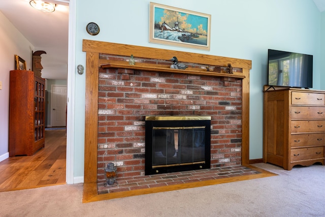 738 Litchfield Rd, Bowdoin, ME 04287 - detailed view of carpet, a brick fireplace, and baseboards
