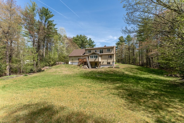 738 Litchfield Rd, Bowdoin, ME 04287 - back of property with stairway, a lawn, a deck, and a chimney