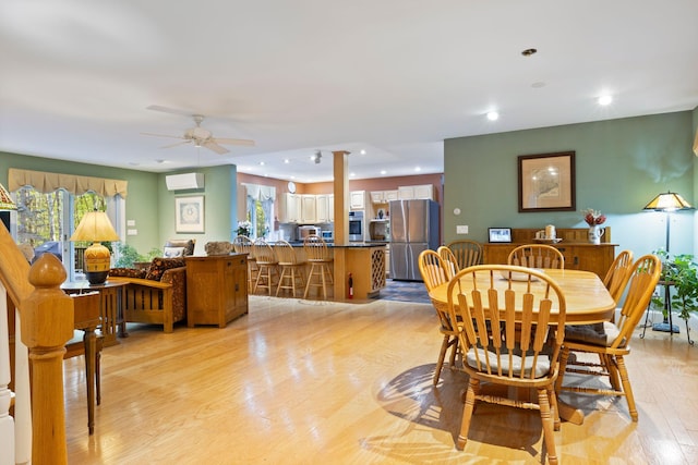 356 Brixham Rd, Eliot, ME 03903 - dining room featuring light wood-style floors, ceiling fan, healthy amount of natural light, a wall unit AC, and recessed lighting