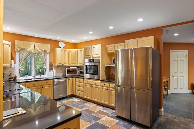 356 Brixham Rd, Eliot, ME 03903 - kitchen with stainless steel appliances, a sink, light brown cabinetry, stone tile flooring, and dark countertops