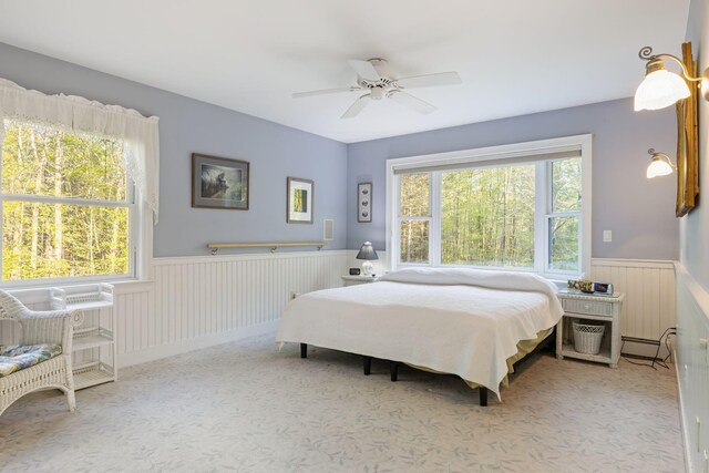 356 Brixham Rd, Eliot, ME 03903 - carpeted bedroom with a wainscoted wall, radiator heating unit, and ceiling fan
