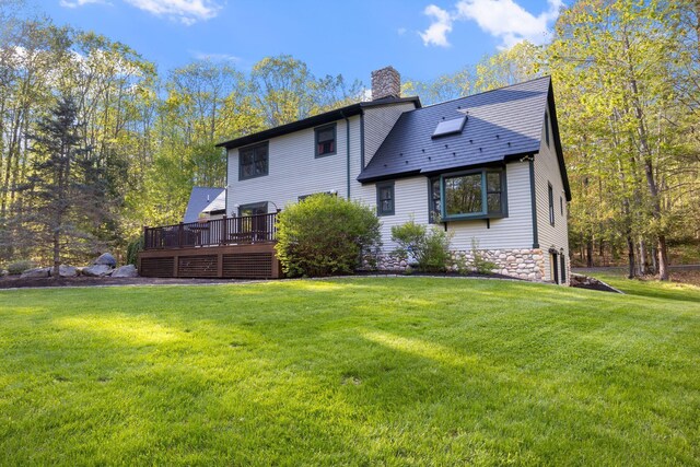 356 Brixham Rd, Eliot, ME 03903 - back of property with a chimney, a lawn, a deck, and stone siding