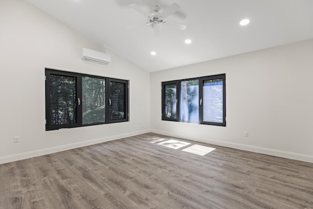5 Zakelo Island Rd, Harrison, ME 04040 - unfurnished room with a wall unit AC, recessed lighting, wood finished floors, lofted ceiling, and baseboards