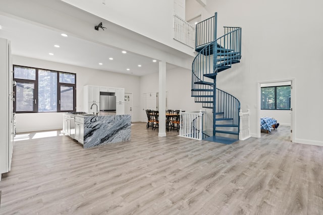 5 Zakelo Island Rd, Harrison, ME 04040 - living room featuring a towering ceiling, stairway, light wood-style flooring, recessed lighting, and baseboards