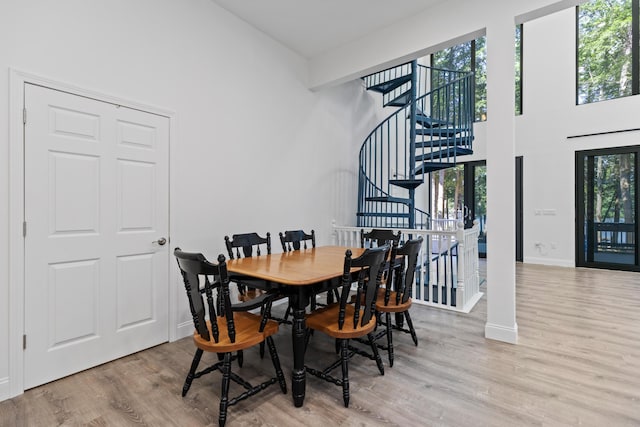 5 Zakelo Island Rd, Harrison, ME 04040 - dining room featuring a high ceiling, wood finished floors, stairway, and baseboards