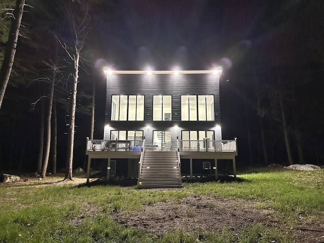 5 Zakelo Island Rd, Harrison, ME 04040 - back of house at night with stairway and a wooden deck