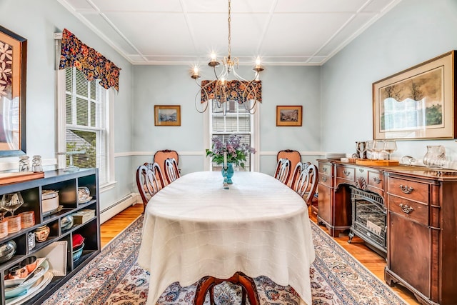 30 Morrill Ave, Waterville, ME 04901 - dining area featuring a chandelier, baseboard heating, and light wood finished floors