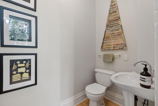 377 Cumberland Ave, Portland, ME 04101 - bathroom featuring toilet, baseboards, and a sink