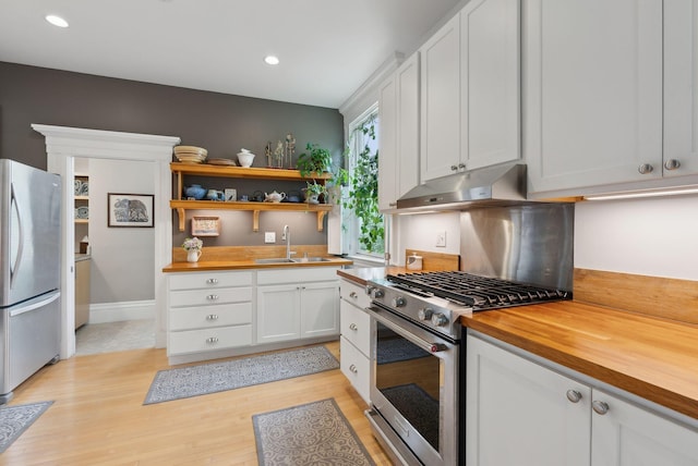 377 Cumberland Ave, Portland, ME 04101 - kitchen featuring stainless steel appliances, butcher block countertops, under cabinet range hood, white cabinets, and recessed lighting