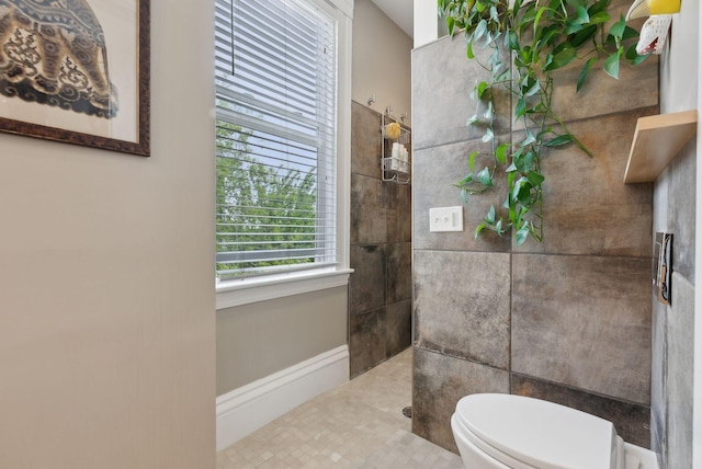 377 Cumberland Ave, Portland, ME 04101 - bathroom featuring a walk in shower, toilet, and baseboards