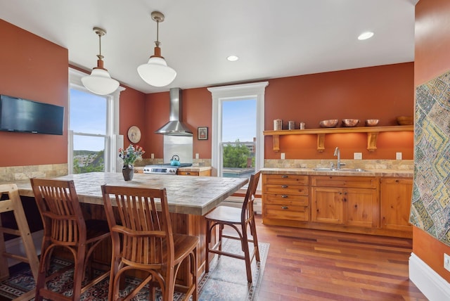 377 Cumberland Ave, Portland, ME 04101 - kitchen featuring a sink, wall chimney range hood, plenty of natural light, wood finished floors, and recessed lighting