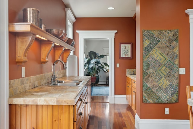 377 Cumberland Ave, Portland, ME 04101 - kitchen with a sink, light wood-style floors, tile counters, and baseboards