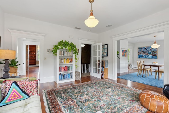 377 Cumberland Ave, Portland, ME 04101 - living room with wood finished floors, french doors, baseboards, and baseboard heating