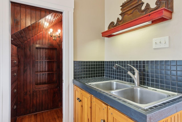 377 Cumberland Ave, Portland, ME 04101 - kitchen featuring a sink, dark countertops, hardwood / wood-style flooring, and decorative backsplash