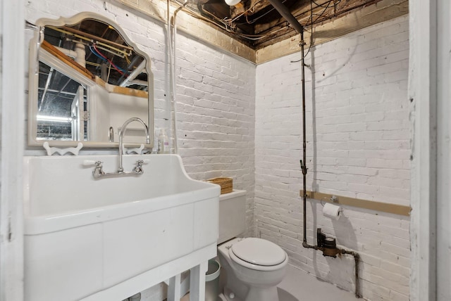 377 Cumberland Ave, Portland, ME 04101 - bathroom featuring brick wall and toilet