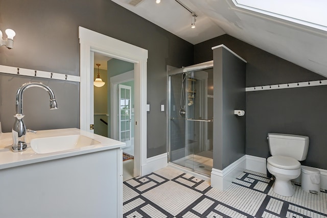 377 Cumberland Ave, Portland, ME 04101 - bathroom with toilet, lofted ceiling, a shower stall, vanity, and track lighting