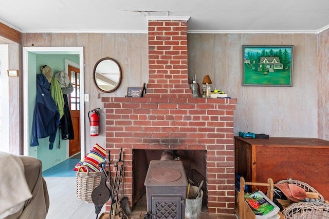 13 Bustins Is, Freeport, ME 04032 - detailed view of a wood stove, a fire extinguisher, ornamental molding, wood finished floors, and wooden walls