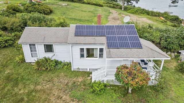 13 Bustins Is, Freeport, ME 04032 - back of property with roof mounted solar panels, roof with shingles, a chimney, and a yard