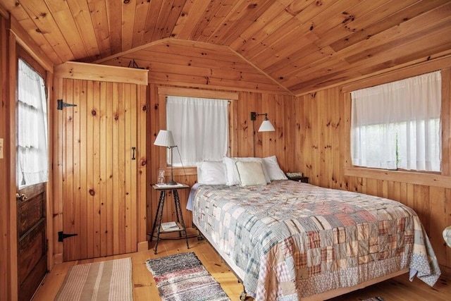 13 Bustins Is, Freeport, ME 04032 - bedroom featuring lofted ceiling, multiple windows, wooden walls, wood ceiling, and wood finished floors