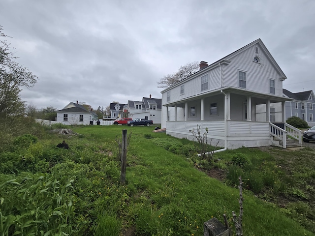 22 Summer St, Lubec, ME 04652 - view of side of property featuring a chimney and covered porch