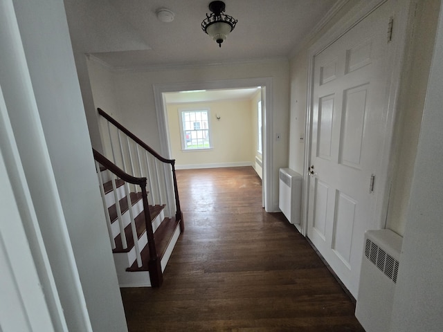 22 Summer St, Lubec, ME 04652 - hallway featuring radiator, dark wood-type flooring, ornamental molding, stairway, and baseboards