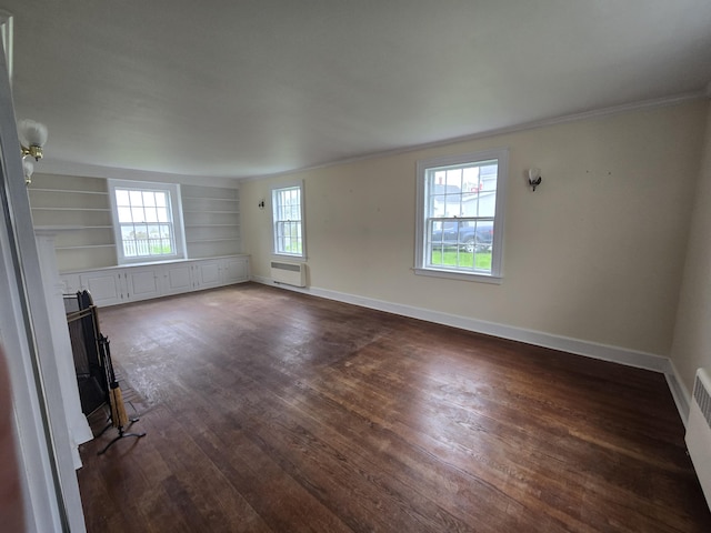22 Summer St, Lubec, ME 04652 - unfurnished living room with crown molding, dark wood-style floors, an AC wall unit, and baseboards