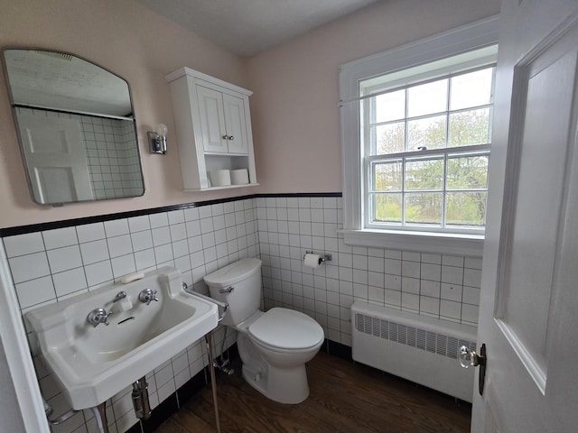 22 Summer St, Lubec, ME 04652 - bathroom with radiator heating unit, tile walls, toilet, wood finished floors, and a wainscoted wall