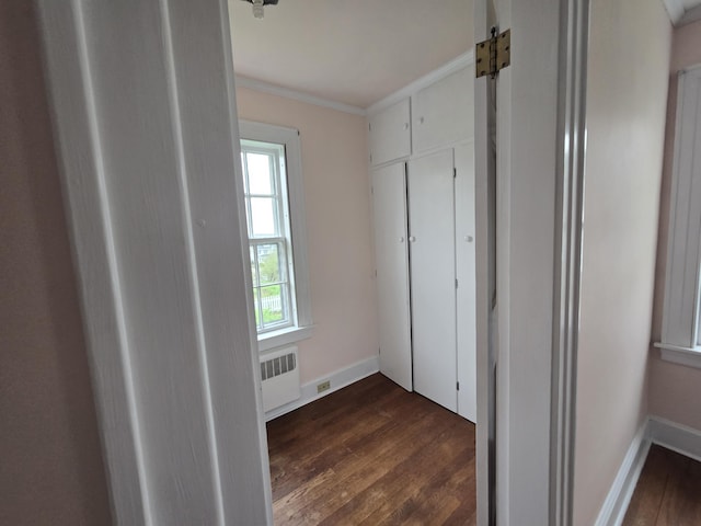 22 Summer St, Lubec, ME 04652 - unfurnished bedroom featuring dark wood-type flooring, crown molding, radiator heating unit, and baseboards