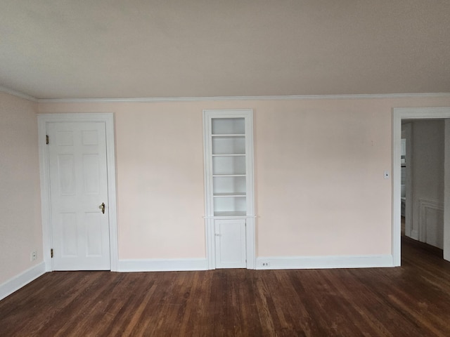 22 Summer St, Lubec, ME 04652 - empty room with dark wood-style flooring, baseboards, built in features, and crown molding
