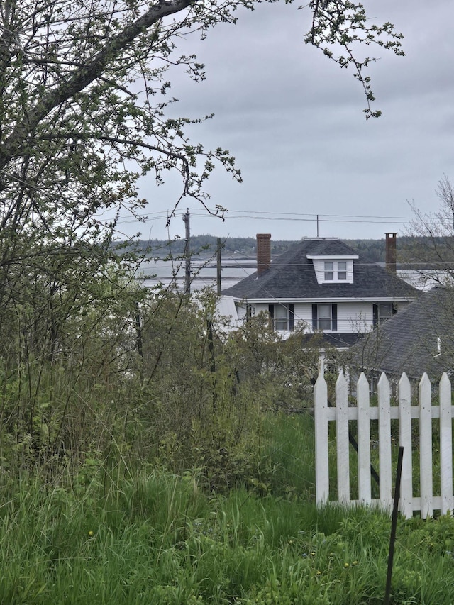 22 Summer St, Lubec, ME 04652 - view of side of home featuring a chimney and a shingled roof