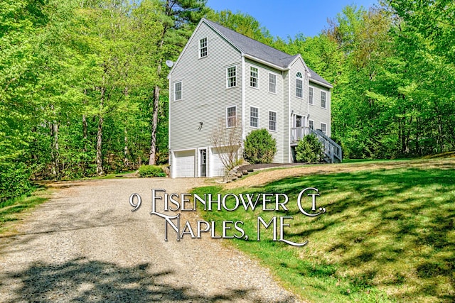 9 Eisenhower Ct, Naples, ME 04055 - view of front facade featuring an attached garage, a front lawn, and driveway