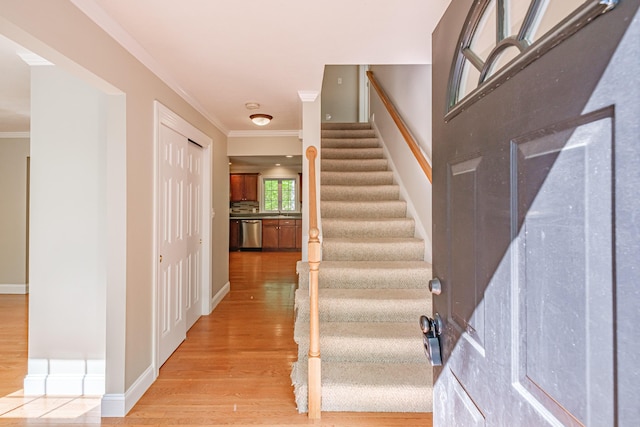 9 Eisenhower Ct, Naples, ME 04055 - foyer entrance with light wood-style floors, stairs, ornamental molding, and baseboards