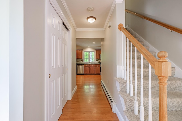 9 Eisenhower Ct, Naples, ME 04055 - hall featuring baseboard heating, crown molding, light wood finished floors, stairs, and a sink