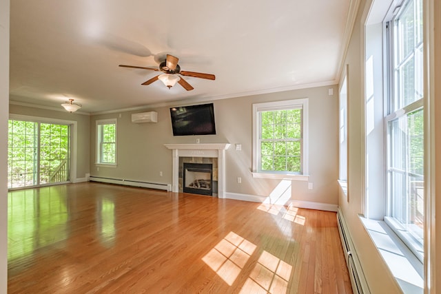 9 Eisenhower Ct, Naples, ME 04055 - unfurnished living room with a baseboard heating unit, a wall unit AC, ornamental molding, a tile fireplace, and light wood-type flooring