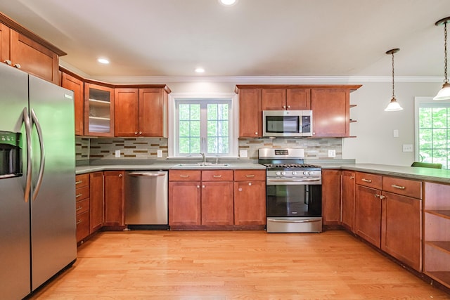 9 Eisenhower Ct, Naples, ME 04055 - kitchen featuring appliances with stainless steel finishes, open shelves, crown molding, brown cabinets, and light wood-style floors