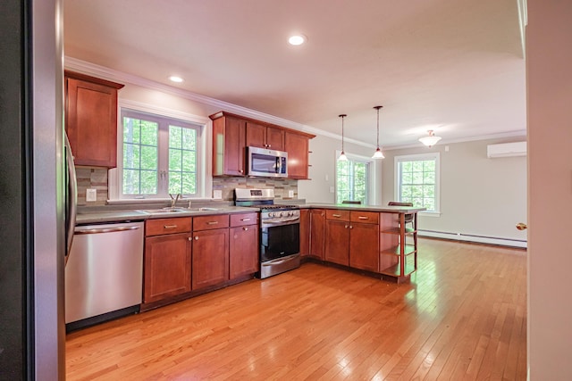 9 Eisenhower Ct, Naples, ME 04055 - kitchen featuring stainless steel appliances, baseboard heating, crown molding, a peninsula, and light wood-style floors