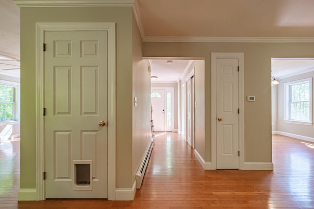 9 Eisenhower Ct, Naples, ME 04055 - hallway featuring baseboard heating, healthy amount of natural light, light wood finished floors, ornamental molding, and baseboards
