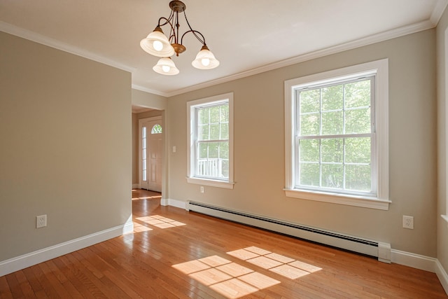 9 Eisenhower Ct, Naples, ME 04055 - spare room featuring a baseboard radiator, light wood-style floors, ornamental molding, baseboards, and a chandelier