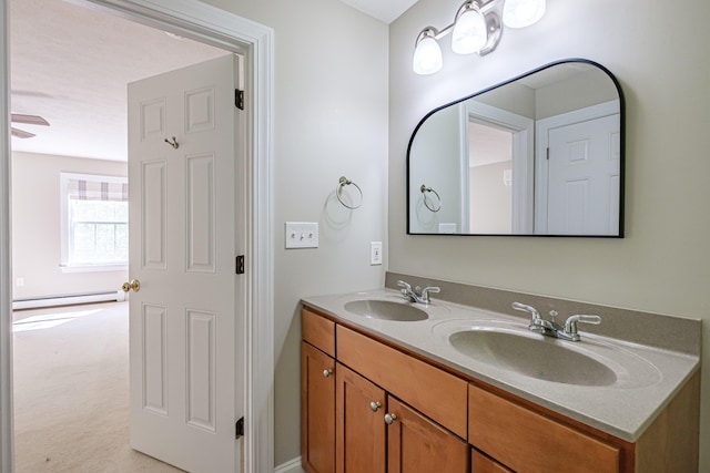 9 Eisenhower Ct, Naples, ME 04055 - bathroom with double vanity and a baseboard radiator
