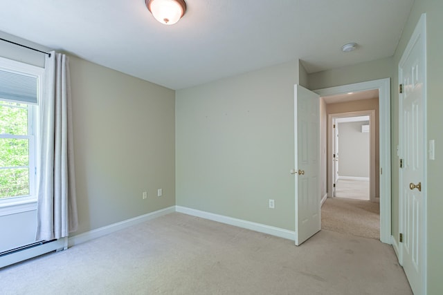 9 Eisenhower Ct, Naples, ME 04055 - empty room featuring light colored carpet, baseboards, and a baseboard radiator
