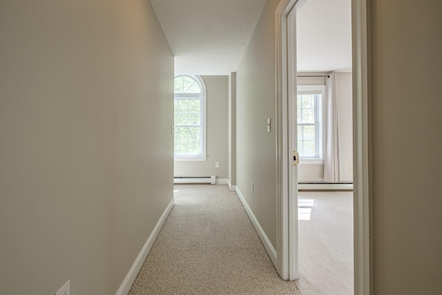 9 Eisenhower Ct, Naples, ME 04055 - hall with a baseboard heating unit, light carpet, and baseboards