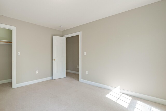 9 Eisenhower Ct, Naples, ME 04055 - unfurnished bedroom with light carpet, baseboards, and a closet